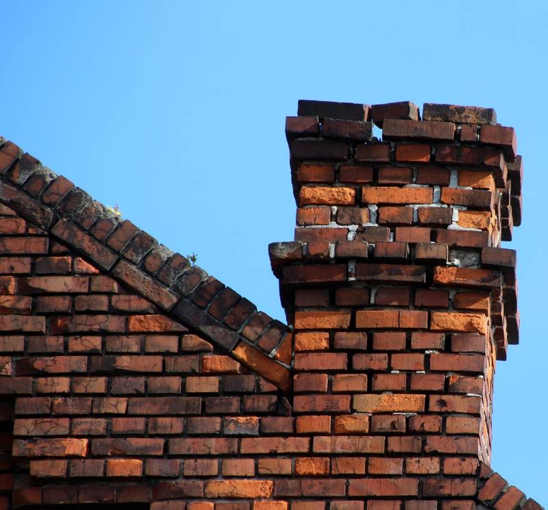 Signs Your Carrollton Home Needs a Chimney Inspection Damaged chimney on an Carrollton home showing cracks and missing mortar